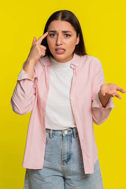 istock Woman tapping finger on temple with sarcastic expression showing disbelief silly irrational decision 2252780168