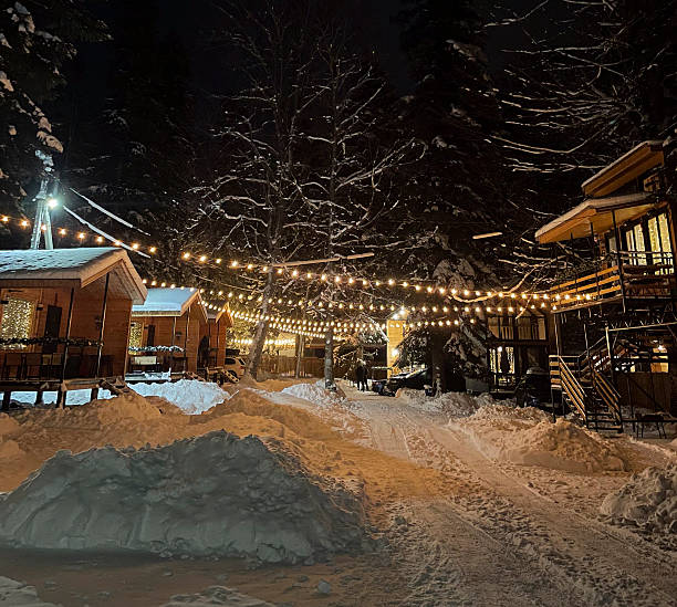 istock A tranquil winter scene features cabins glowing with lights under a starry sky, surrounded by snow 2252782474