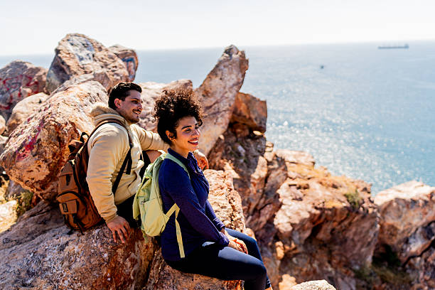Couple looking at view on mountain peak