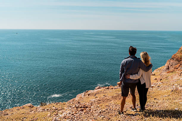 Couple looking at view on mountain peak