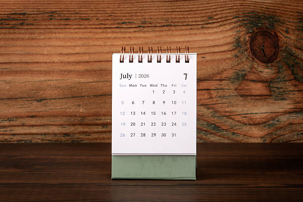 istock July 2026 Desk Calendar on Wooden Workspace Surface 2252786189