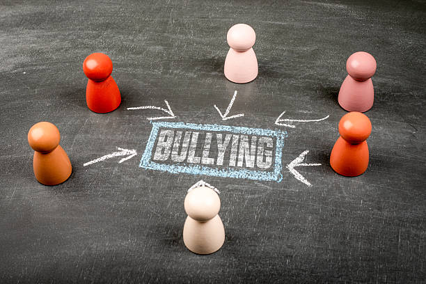 istock Bullying Concept Illustrated With Chalkboard Arrows And Figures Around Text 2252786197