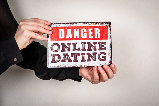 istock Danger Online Dating Message Displayed On Warning Sign Held In Hands 2252786199