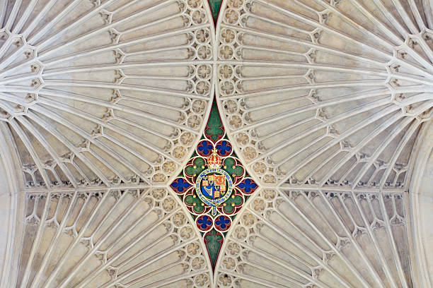 A detailed view of the fan-vaulted stone ceiling inside Bath Abbey in Bath, Somerset, England, UK. The Gothic ceiling features radiating ribs and carved decorative elements characteristic of late medieval ecclesiastical architecture.