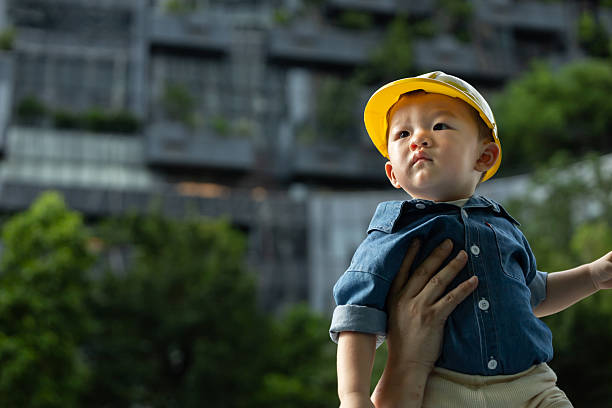 Future builder concept with toddler in hard hat