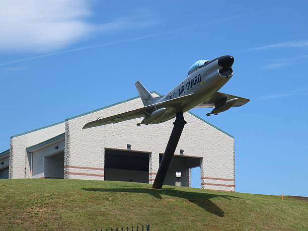 McDonnell Douglas F-101B Voodoo jet mounted on pedestal in front of South Carolina Air National Guard facility. Angled skyward with tail number 24442, the Cold War-era interceptor honors regional aviation history and military service. At Charlotte Douglas International Airport. Charlotte, North Carolina, USA May 06, 2016