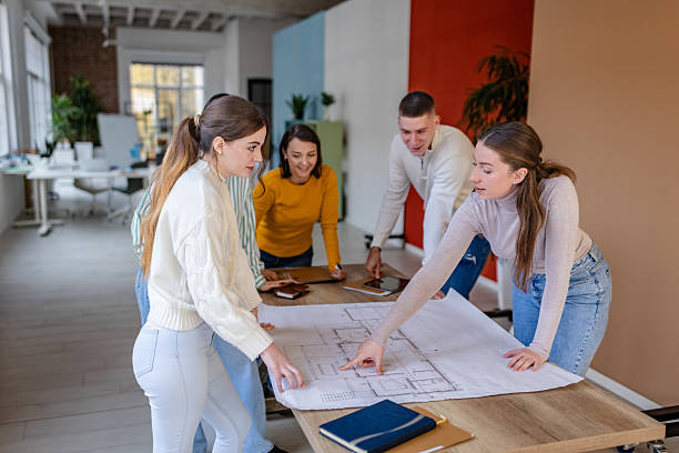 istock Colleagues collaborate on project plans in modern office during work hours 2252796715