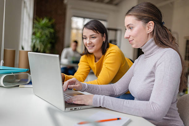 istock Colleagues work together at a desk during the day in a modern office environment 2252797047