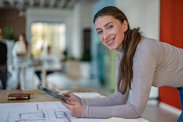 istock Colleagues working together in an office space with documents and digital devices during a typical workday 2252797200
