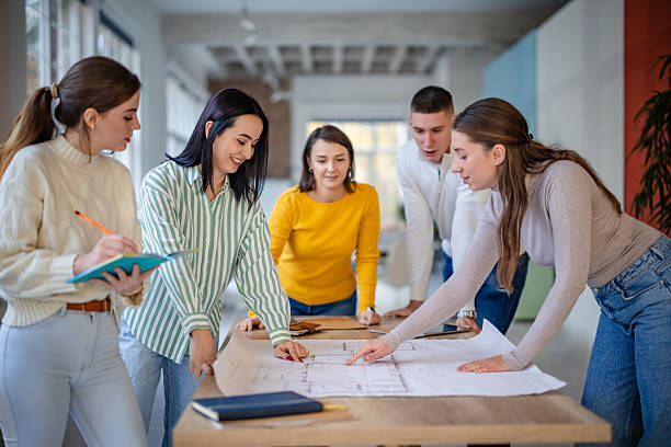 istock Group of adults engaged in a work meeting in a modern office setting planning and discussing project details 2252798595