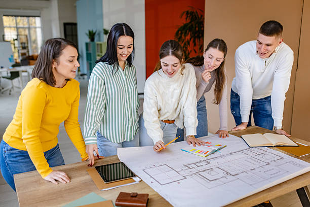 istock Group of professionals collaborates on project plans in a modern office setting during working hours 2252799058