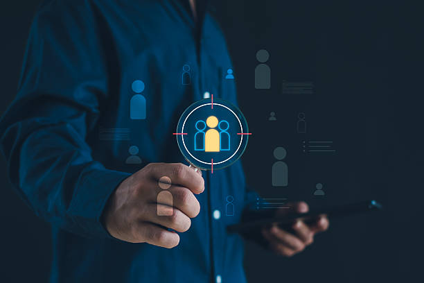 istock Business holding magnifier targeting digital customer icons for audience analysis, user profiling and data driven marketing strategy, concept of CRM, recruitment, analytics and customer segmentation. 2252800409