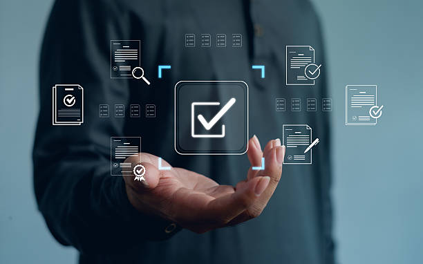 istock Digital document approval and business verification concept with virtual check mark and file icons above human hand, showing compliance, quality control, workflow management, data security. 2252800413