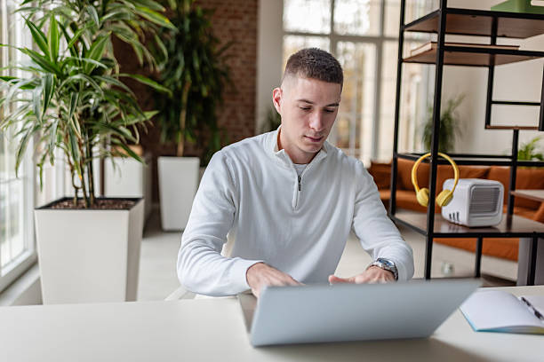 istock Working adult engaged with laptop in modern office setting during daytime 2252801935