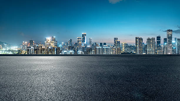 istock Empty asphalt road with a modern city skyline at night. 2252802971