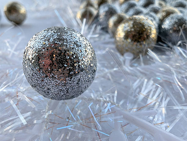 One silver Christmas ball and snowflakes on the white background