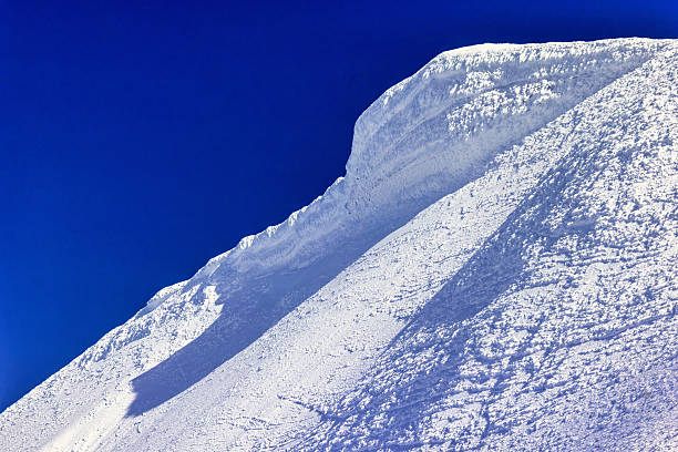Snow capped, wind blown mountain peak near Cooke City, Montana, USA, North America.