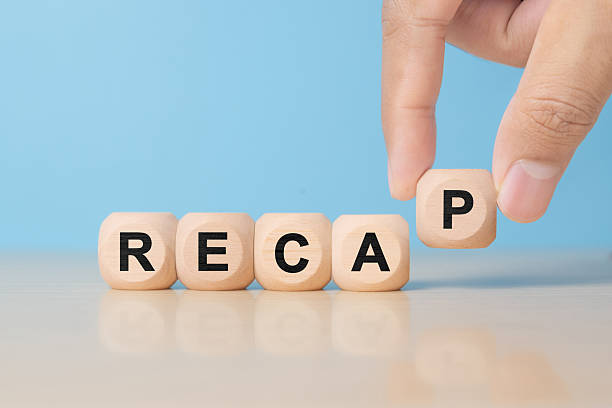 istock recap sign made of blocks on a table with a reflective surface, blue background 2252813481