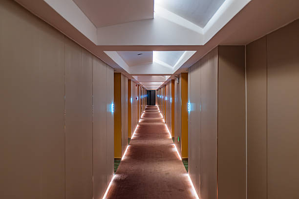 istock Symmetrical view of a modern hotel corridor with ambient floor lighting 2252815877