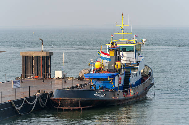 Terneuzen, Netherlands - March 24, 2012. Outdoor scene showing tug boats in the harbour of Terneuzen.