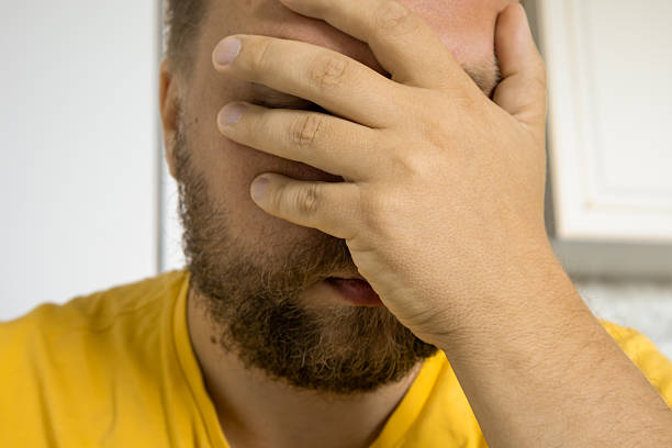 istock Bearded man facepalm close-up in yellow shirt, stress concept 2252817543