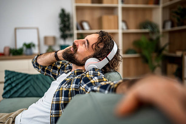istock Man enjoying music relaxing at home 2252818211
