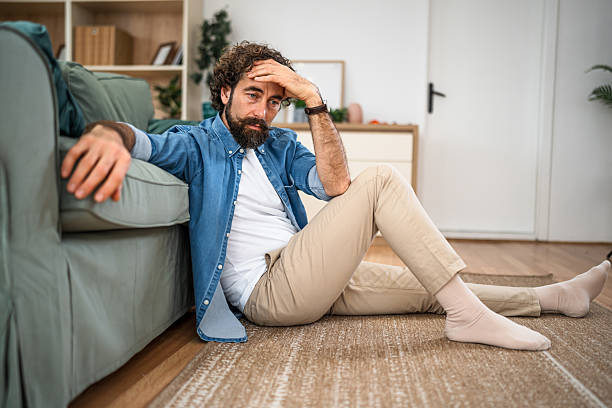 istock Man experiencing stress and depression at home 2252818221