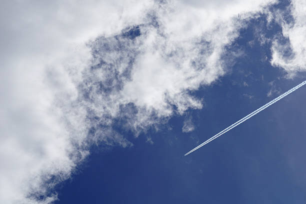 istock White trail of an airplane engine high in the blue sky 2252818274