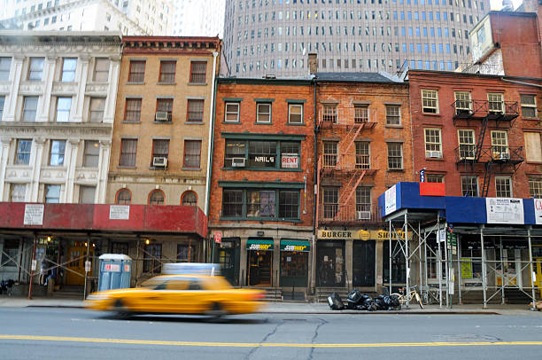 Jersey City, United States - July 3, 2009. Long exposure shot showing a car passing in front of a historic store front in lower manhattan.