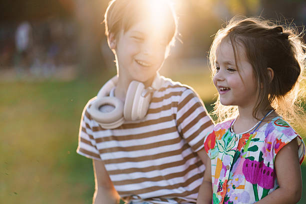 istock Siblings enjoying sunny day outdoors laughing together. 2252822498