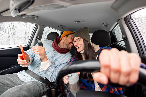 istock Couple using smart phone gps while travelling to winter vacation by car 2252823763