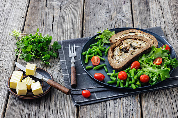 istock Finnish Kalakukko, fish pie on plate with veggies 2252824153