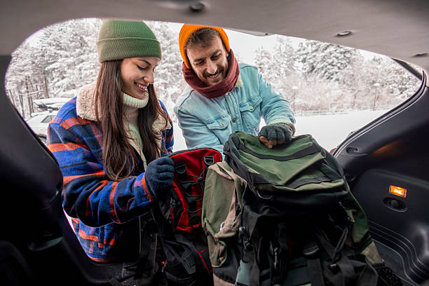istock Couple packing backpacks into car trunk, getting ready for winter vacation road trip 2252824689