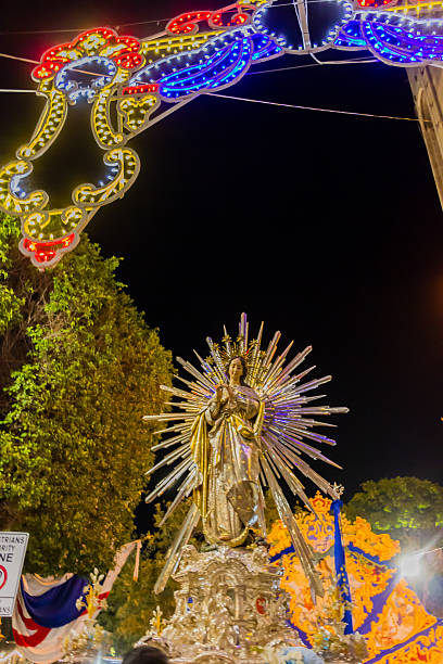 istock Religious Night Procession With Illuminated Arch, Radiant Virgin Mary Statue, and Decorative Lights 2252826612