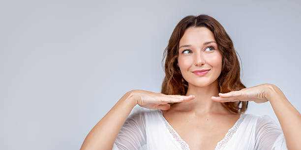 istock Cheerful Woman Framing Face With Hands and Smiling Upward 2252829446