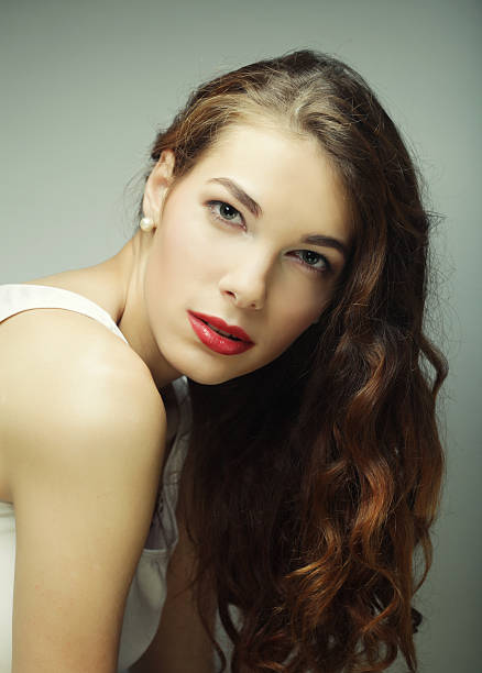 calm and friendly blond woman, over grey background