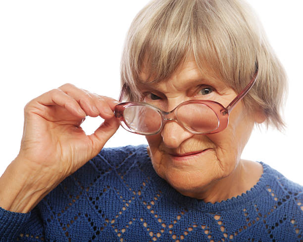 A nice looking senior woman looking down over the tp of her glasses