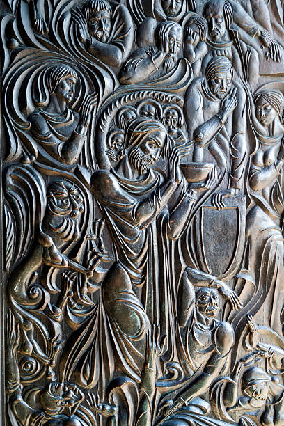 Veliko Tarnovo, Bulgaria - August 8, 2025: Detailed bronze relief sculpture depicting expressive biblical figures and dramatic flowing forms, located at the Patriarchal Cathedral on Tsarevets Hill in Veliko Tarnovo, Bulgaria.