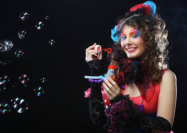 istock fashion model with creative make-up blowing soap bubbles. Doll style. 2252830912