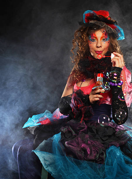 istock fashion model with creative make-up blowing soap bubbles. Doll style. 2252830914