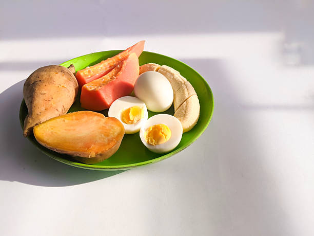istock Healthy foods: bananas, boiled sweet potatoes, boiled eggs, and papaya. 2252835166