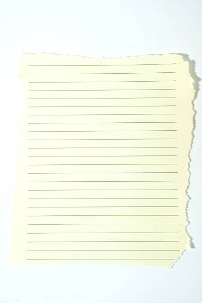 istock Blank lined paper with torn edges isolated on white. A vintage cream notebook page perfect for graphic design notes, memos, and scrapbooking. 2252836158
