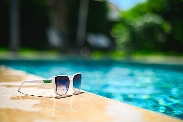 sunglasses are lying near the pool