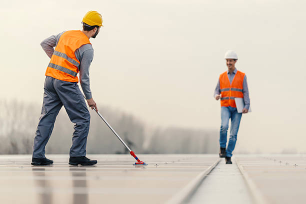 istock Workers maintaining solar panels on a renewable energy urban rooftop 2252837653