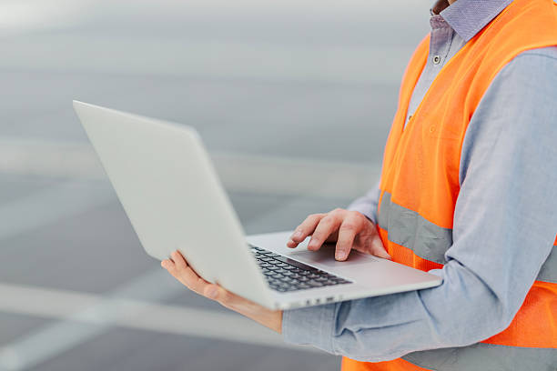 istock Engineer working on laptop wearing safety vest 2252837716