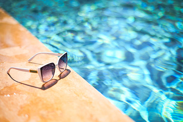 sunglasses are lying near the pool