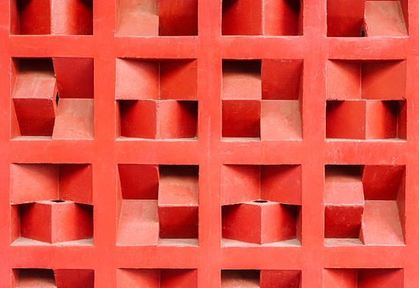 Terracotta red rooster wall texture with a geometric pattern. This ventilation block background features a repeating 3D square design, perfect for architectural and graphic elements.