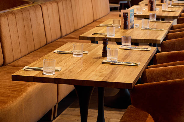 istock informal communal area with warm decor, shared wooden tables with soft seating and inviting ambiance 2252839681