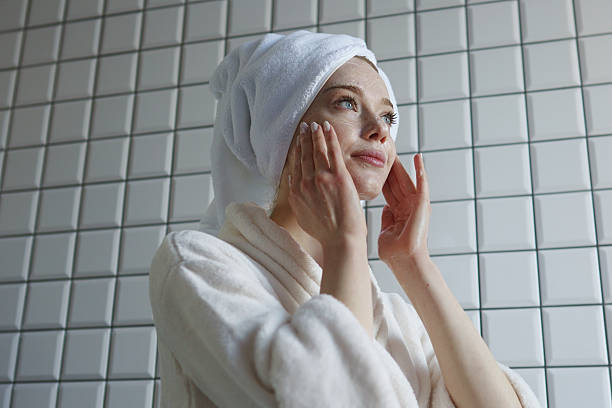 istock Side profile woman contemplating while applying facial mask 2252841649
