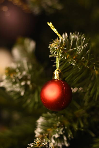 istock Red Christmas ornament among artificial tree branches 2252841986